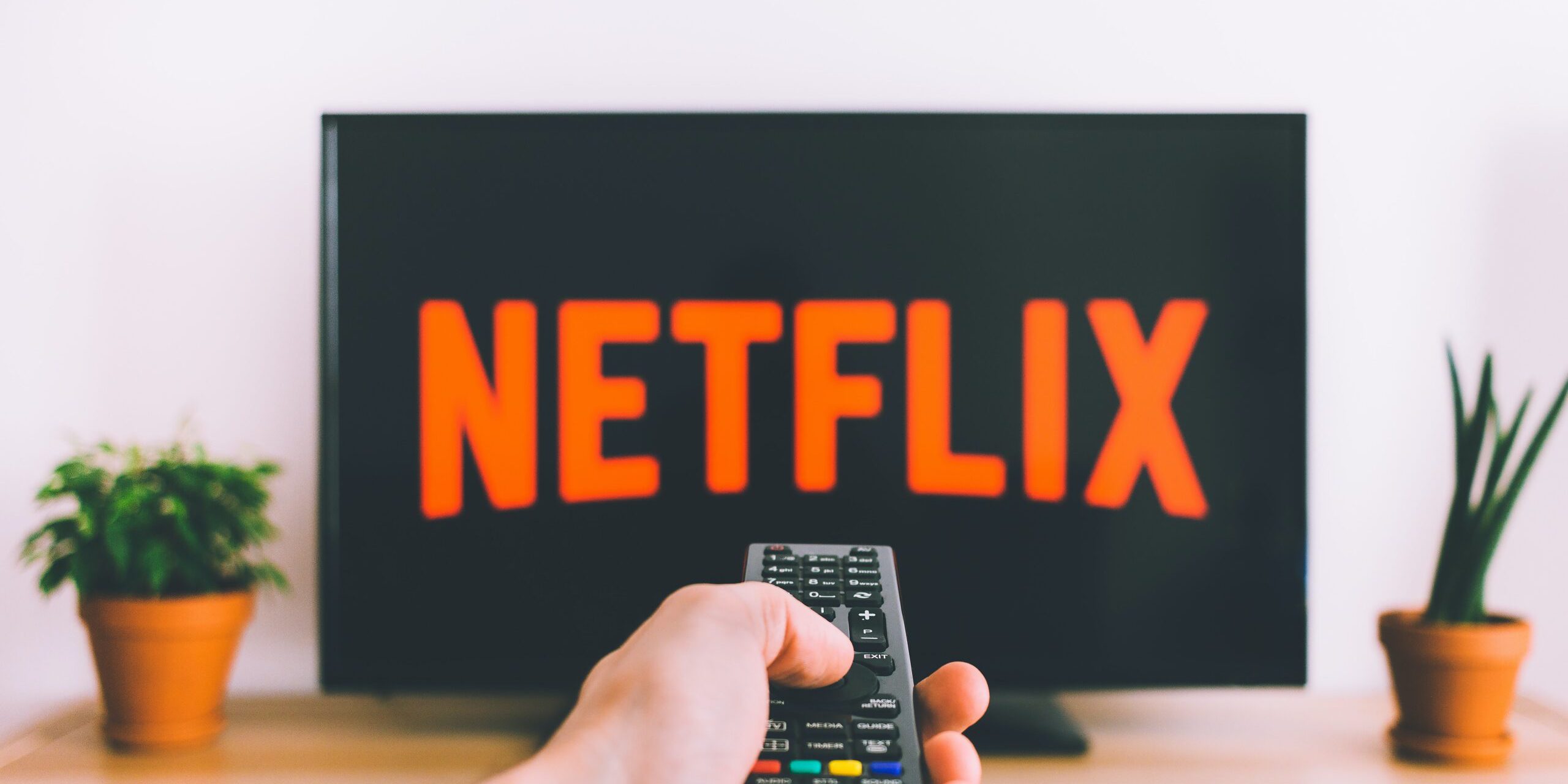 6-Immediate-Steps-You-Should-Take-If-Your-Netflix-Account-is-Hacked-Featured-Image-scaled.jpg Free Person Holding a Remote Control Stock Photo