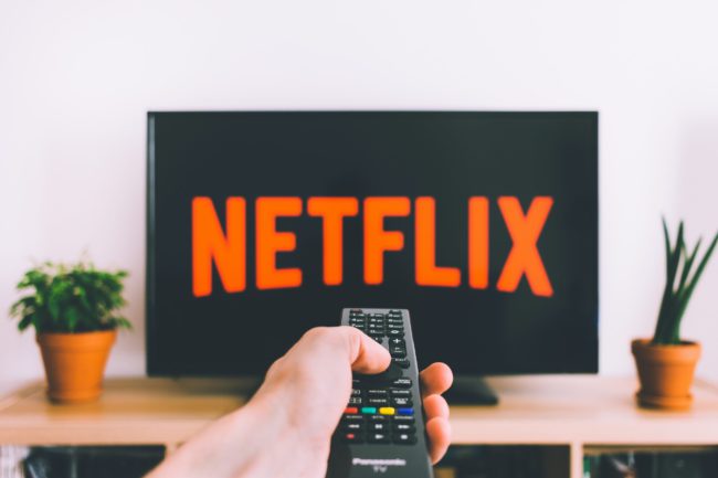 6-Immediate-Steps-You-Should-Take-If-Your-Netflix-Account-is-Hacked-Featured-Image-scaled.jpg Free Person Holding a Remote Control Stock Photo